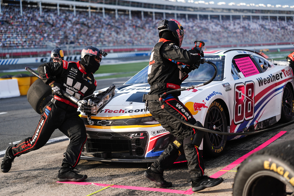 FILE - The pit crew for Shane van Gisbergen (88) rushes to complete a pit stop during a NASCAR Cup Series auto race at Charlotte Motor Speedway, Oct. 5, 2025, in Concord, N.C. (AP Photo/Matt Kelley, File)