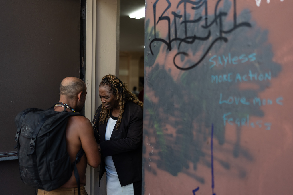 Evangelist Geraldine Hughes, right, a judge at Skid Row’s inaugural talent show, prays with a homeless person outside Lifeway Church in downtown Los Angeles, Saturday, Sept. 19, 2026. (AP Photo/Jae C. Hong)