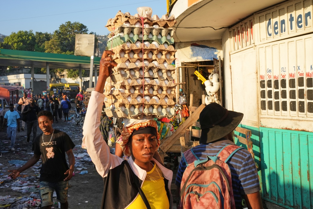 A street vendor balances flats of eggs on her head in the Petion-Ville neighborhood of Port-au-Prince, Haiti, Thursday, Feb. 19, 2026. (AP Photo/Odelyn Joseph)