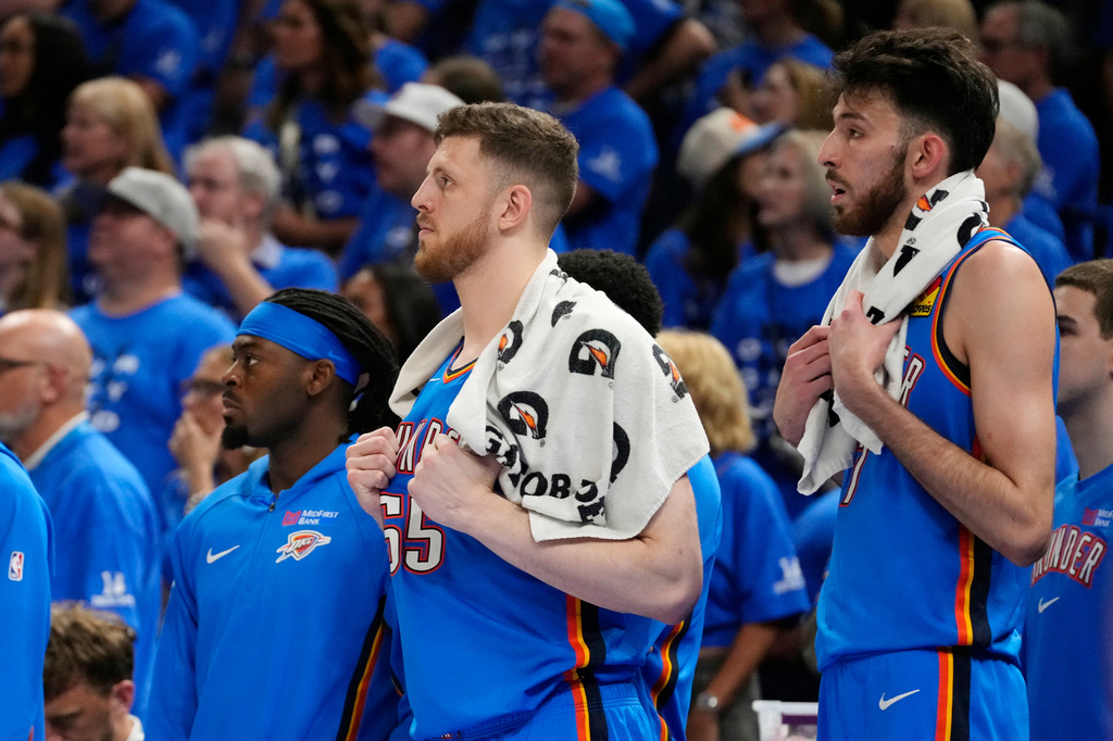 Oklahoma City Thunder guard Luguentz Dort, left, and Thunder centers Isaiah Hartenstein, center, and Chet Holmgren watch the action on the court from the team bench during the second half of Game 7 of the Western Conference finals of the NBA basketball playoffs series against the San Antonio Spurs, Saturday, May 30, 2026, in Oklahoma City. (AP Photo/Tony Gutierrez)