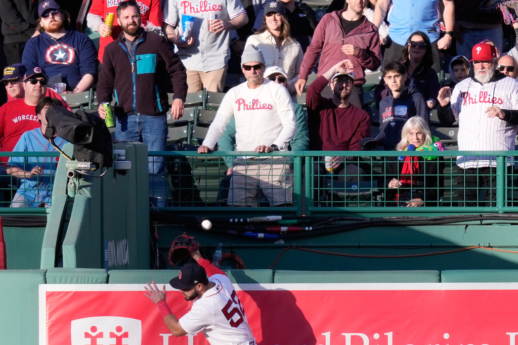 Boston Red Sox right fielder Wilyer Abreu (52) tries but can't make the catch on a solo home run by Philadelphia Phillies designated hitter Kyle Schwarber during the first inning of a baseball game, Tuesday, May 12, 2026, in Boston. (AP Photo/Charles Krupa)