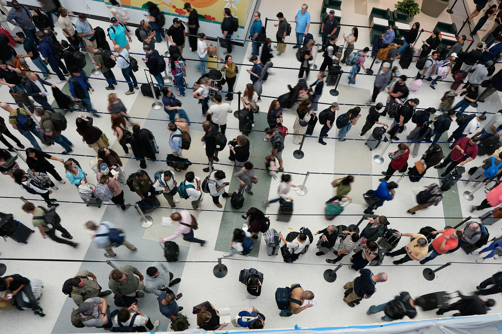 FILE - Travelers wait in long security checkpoint lines at George Bush Intercontinental Airport March 27, 2026, in Houston. (AP Photo/David J. Phillip, File)