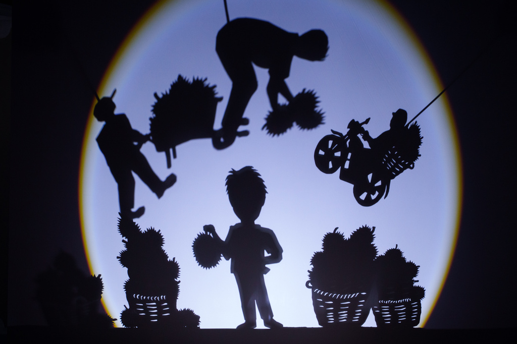 A shadow performance depicting the harvesting and transportation of durians is presented at KLDEX (Kuala Lumpur Durian Experience Centre) in Kuala Lumpur, Malaysia, Friday, June 26, 2026. (AP Photo/Vincent Thian)