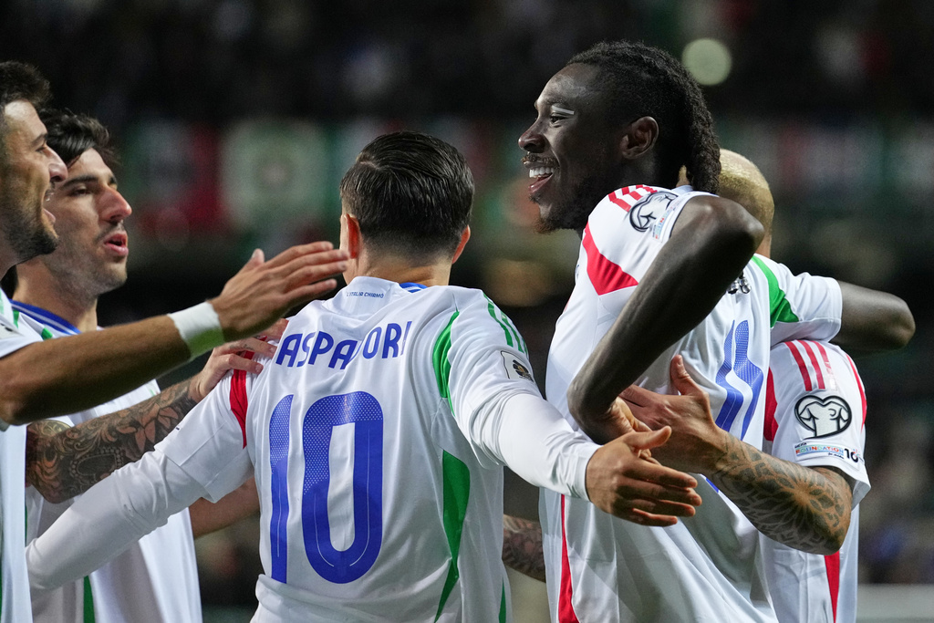 Italy's Moise Kean, right, celebrates with teammates after scoring the opening goal during a World Cup 2026 group I qualifying soccer match between Estonia and Italy in Tallinn, Estonia, Saturday, Oct. 11, 2025. (AP Photo/Sergei Grits)