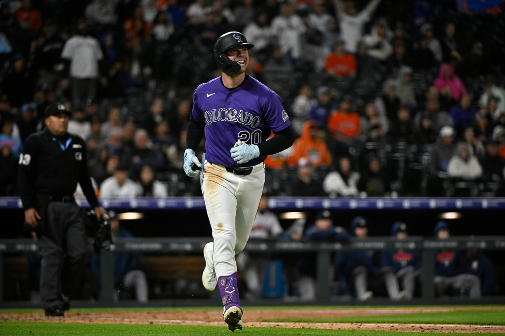 Colorado Rockies' Troy Johnston smiles while rounding the bases after hitting a one-run home run off of Houston Astros relief pitcher Ryan Weiss in the sixth inning of a baseball game Monday, April 6, 2026, in Denver. (AP Photo/Geneva Heffernan)