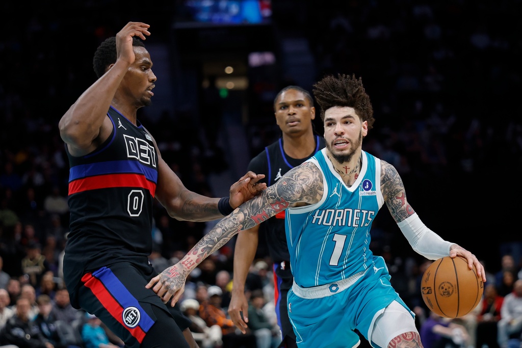 Charlotte Hornets guard LaMelo Ball (1) drives against Detroit Pistons center Jalen Duren (0) during the second half of an NBA basketball game in Charlotte, N.C., Monday, Feb. 9, 2026. (AP Photo/Nell Redmond)