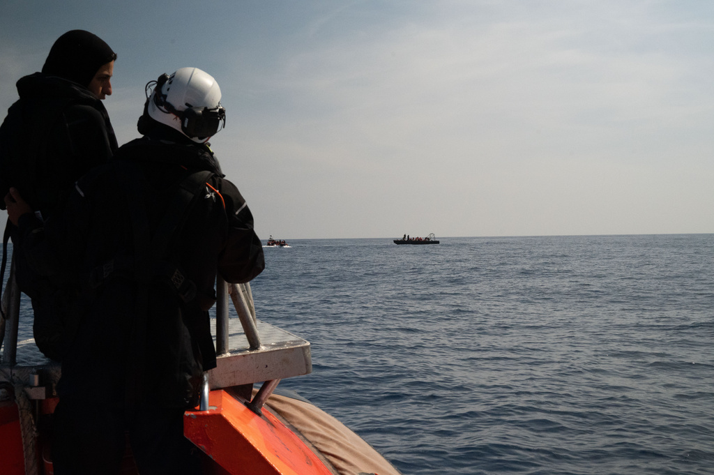 This photo released by Sea-Watch shows the crew of migrant rescue ship Sea-Watch 5 approaching a boat in distress with people on board in an area of the Mediterranean patrolled by Libyan authorities, Monday, May 11, 2026. The boat in the distance at left is one one of their speedboats, according to Sea-Watch. (Leo Spartacus/Sea-Watch via AP)