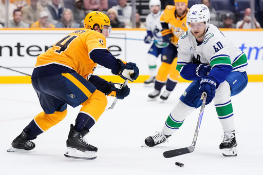 Vancouver Canucks center Elias Pettersson (40) skates the puck past Nashville Predators defenseman Spencer Stastney, left, during the third period of an NHL hockey game Thursday, Oct. 23, 2025, in Nashville, Tenn. (AP Photo/George Walker IV) Vancouver Canucks center Elias Pettersson (40) skates the puck past Nashville Predators defenseman Spencer Stastney, left, during the third period of an NHL hockey game Thursday, Oct. 23, 2025, in Nashville, Tenn. (AP Photo/George Walker IV)