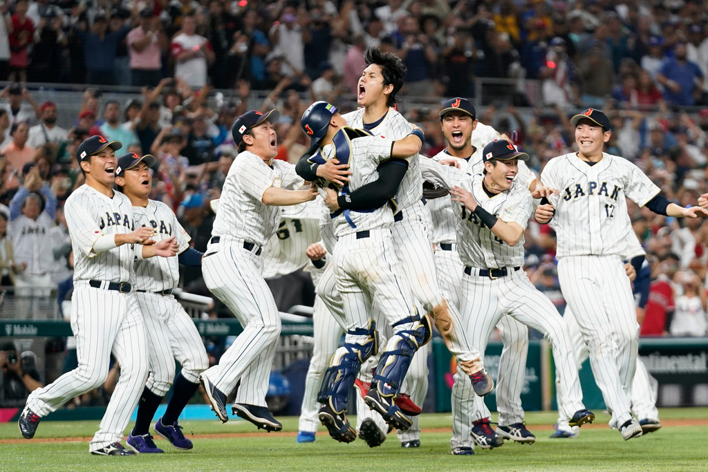 FILE - Japan's Shohei Ohtani, center, celebrates with teammates after defeating the United States in the championship game of the World Baseball Classic, Tuesday, March 21, 2023, in Miami. (AP Photo/Wilfredo Lee, File)