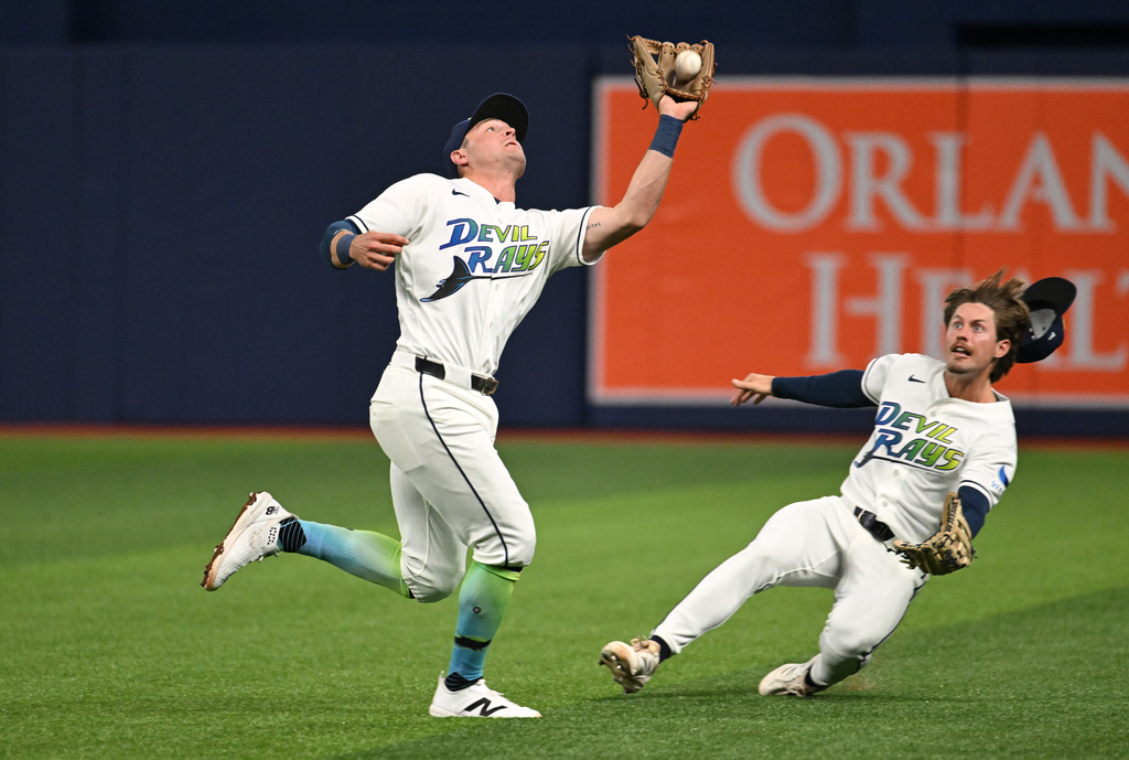 Tampa Bay Rays second baseman Ben Williamson, left, makes the catch on a ball popped up by Minnesota Twins' Royce Lewis (not shown) during the fourth inning of a baseball game Friday, April 24, 2026, in St. Petersburg, Fla. (AP Photo/Jason Behnken)