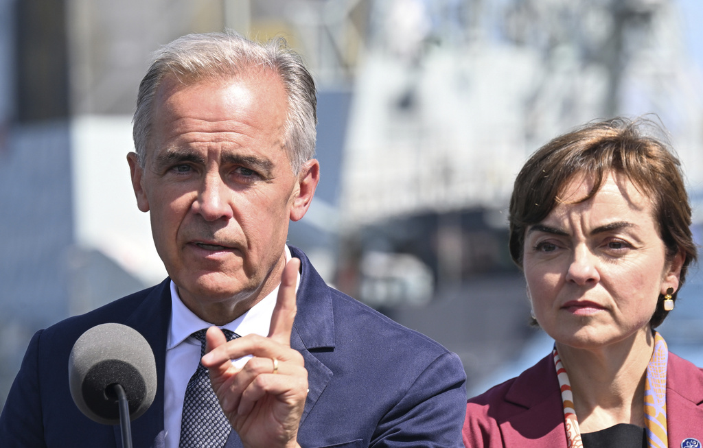 Canadian Prime Minister Mark Carney speaks as he announces a $11.3 billion contract for icebreakers at the Davie shipyard in Levis, Quebec, Monday, Aug. 24, 2026. Quebec Premier Christine Frechette, right, looks on. (Jacques Boissinot/The Canadian Press via AP)