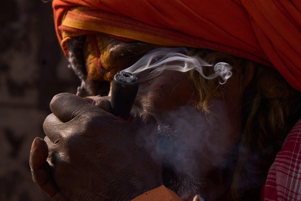 A holy man smokes marijuana during Maha Shivaratri festival at the Pashupatinath temple premises in Kathmandu, Nepal, Sunday, Feb. 15, 2026. (AP Photo/Niranjan Shrestha)