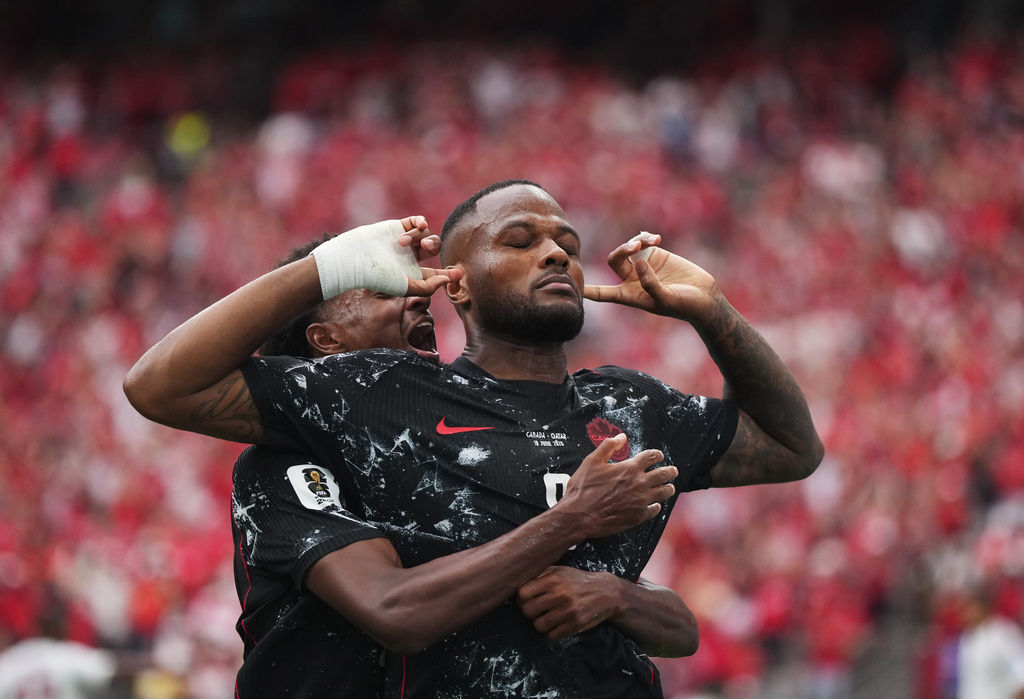 Canada's Cyle Larin (9) celebrates after scoring his sides opening goal during World Cup Group B soccer match between Canada and Qatar in Vancouver, British Columbia, Thursday, June 18, 2026. (Darryl Dyck/The Canadian Press via AP)