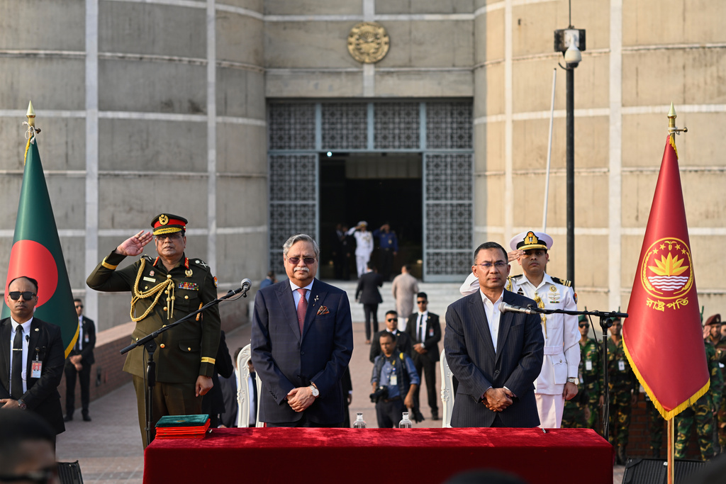 Tarique Rahman, Chairperson of the Bangladesh Nationalist Party, right, stand with Bangladesh President Mohammed Shahabuddin for national anthem after Rahman was sworn in as country's prime minister during a ceremony at the National Parliament in Dhaka, Bangladesh, Tuesday, Feb. 17, 2026. (AP Photo/Mahmud Hossain Opu)