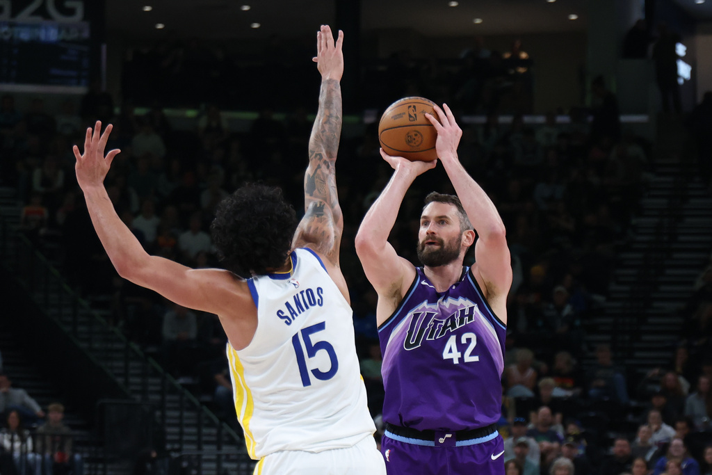 Utah Jazz forward Kevin Love (42) shoots over Golden State Warriors forward Gui Santos (15) during the first half of an NBA basketball game, Monday, March 9, 2026, in Salt Lake City. (AP Photo/Rob Gray)