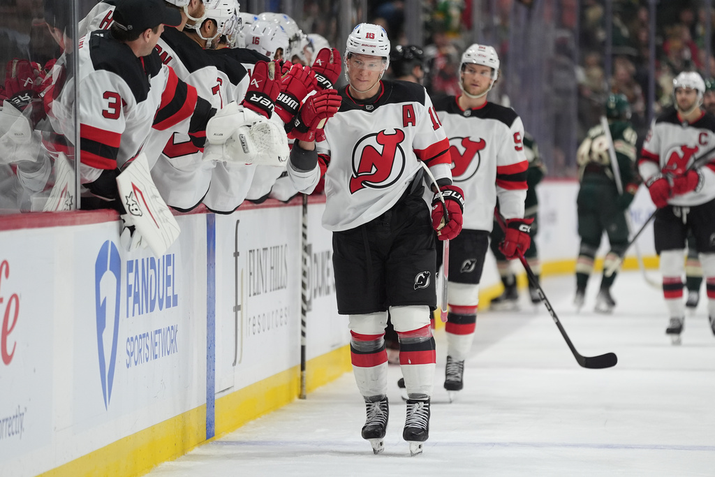 New Jersey Devils left wing Ondrej Palat (18) celebrates with teammates after scoring during the third period of an NHL hockey game against the Minnesota Wild, Monday, Jan. 12, 2026, in St. Paul, Minn. (AP Photo/Abbie Parr)