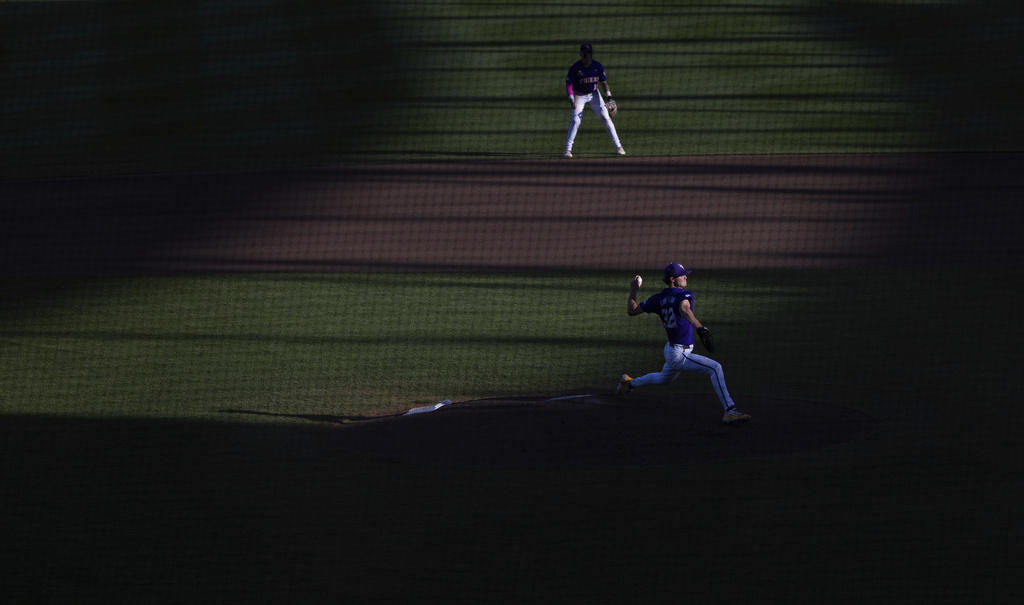 FILE - LSU starting pitcher Kade Anderson, bottom, throws against Coastal Carolina in the fourth inning of Game 1 of the NCAA College World Series baseball finals in Omaha, Neb., Saturday, June 21, 2025. (AP Photo/Rebecca S. Gratz, File)