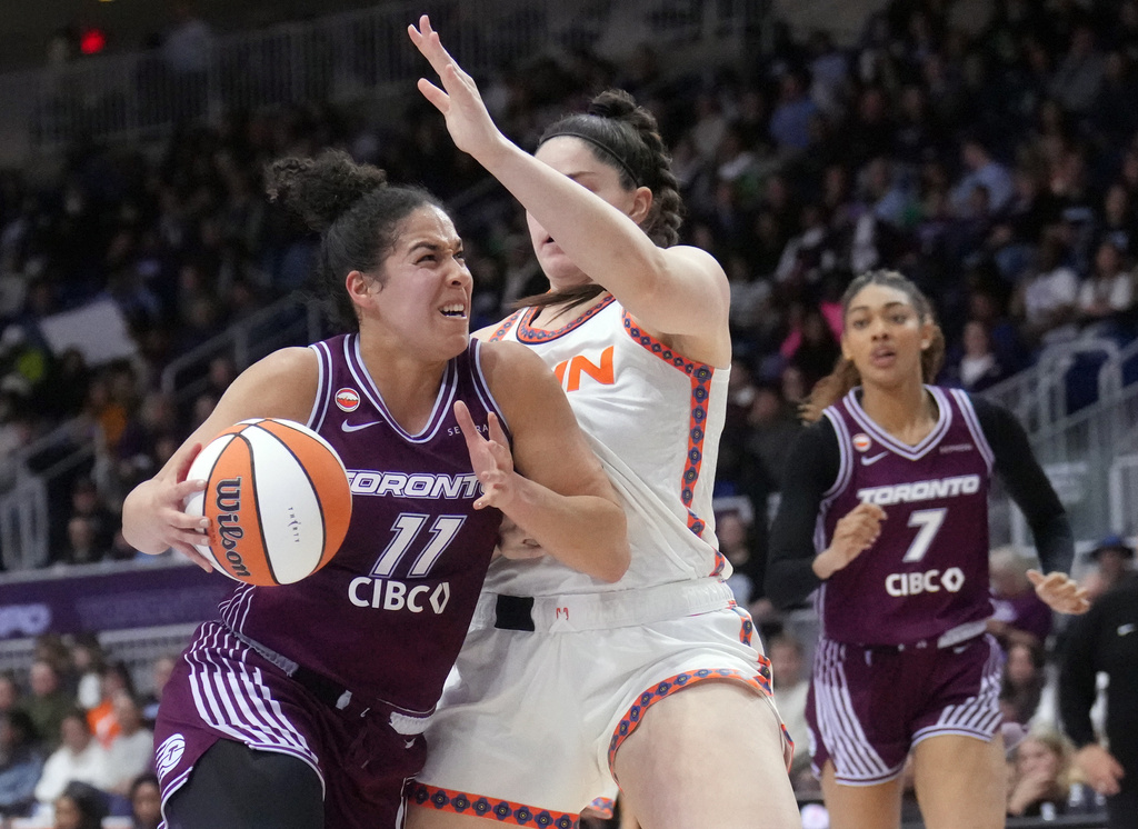 Toronto Tempo guard Kia Nurse (11) drives past Connecticut Sun Raegan Beers (15) during second half pre-season WNBA basketball game in Toronto, Wednesday, April 29, 2026. (Nathan Denette/The Canadian Press via AP)