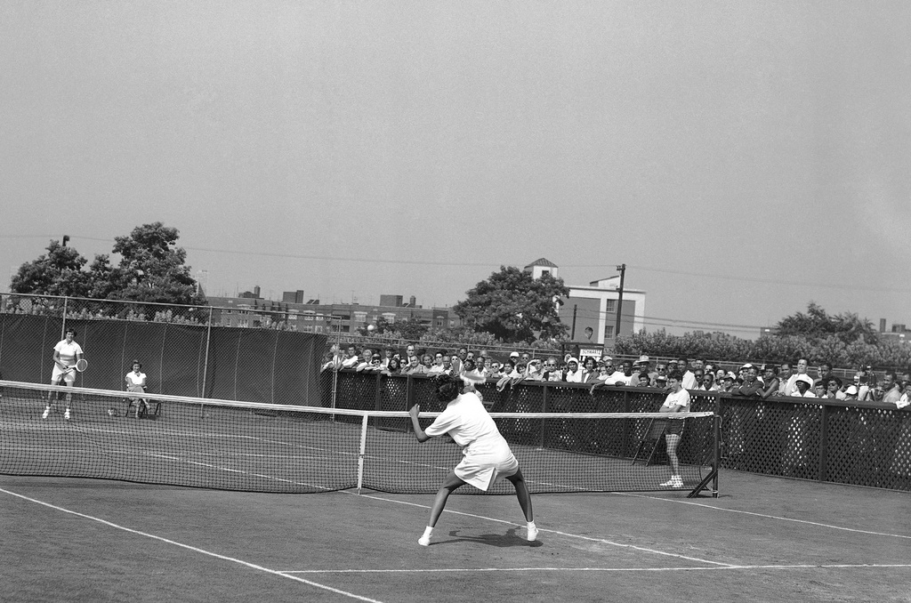 FILE - Althea Gibson, forecourt, of New York City, makes a point return to Barbara Knapp of England during the National Tennis Championship in Forest Hills, New York, Aug. 28, 1950. (AP Photo/Harry Harris,File)