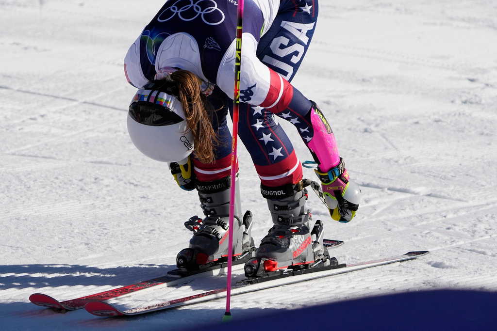 United States' Paula Moltzan unlatches her boots at the finish area of an alpine ski, women's giant slalom race, at the 2026 Winter Olympics, in Cortina d'Ampezzo, Italy, Sunday, Feb. 15, 2026. (AP Photo/Andy Wong)
