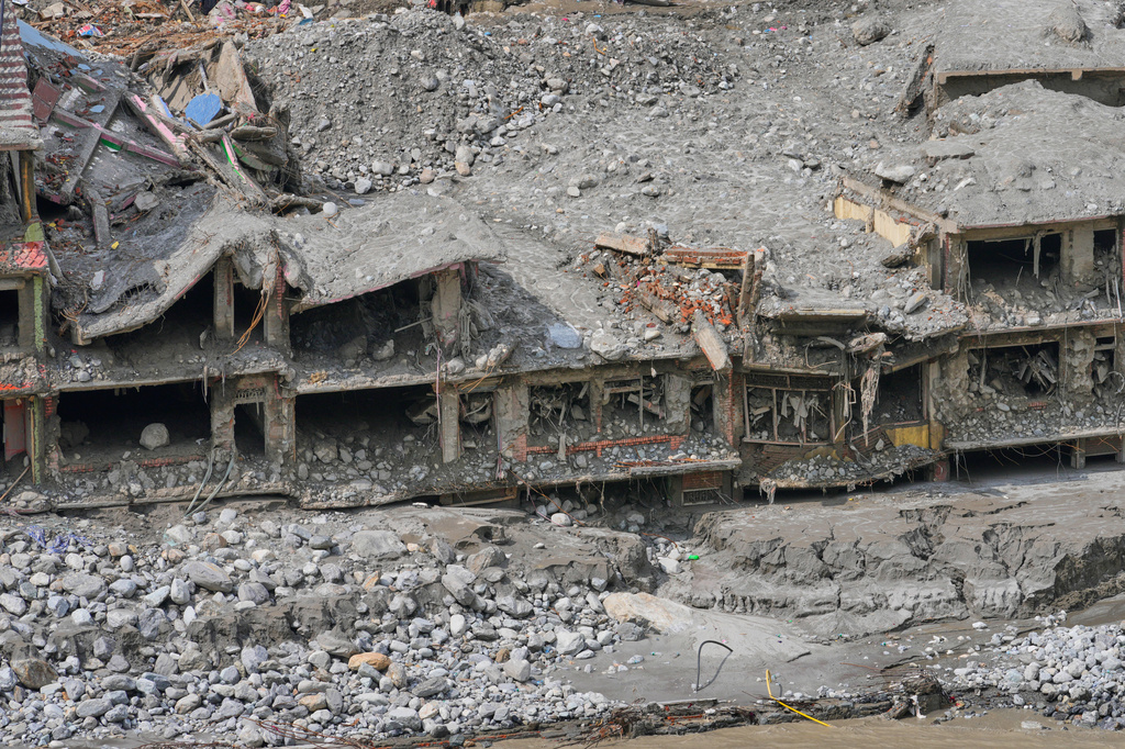FILE - Houses destroyed by recent flash floods stand amid thick layers of sludge, mud and debris in Nepal's Nuwakot district, Sept. 8, 2026. (AP Photo/Dar Yasin, File)