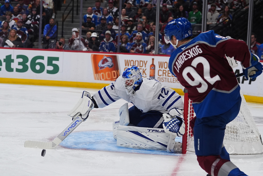 Toronto Maple Leafs goaltender Sergei Bobrovsky, left, makes a stick-save of a shot by Colorado Avalanche left wing Gabriel Landeskog, right, in the first period of an NHL hockey game Saturday, Oct. 10, 2026, in Denver. (AP Photo/David Zalubowski)