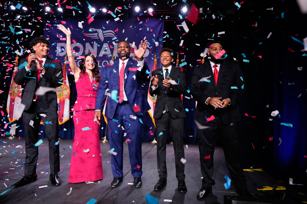 Florida Republican gubernatorial candidate Byron Donalds, center, waves next to his wife Erika, while standing on stage with their children Darin, left, Damon, second from left, and Mason during a primary election party Tuesday, Aug. 18, 2026, in Orlando, Fla. (AP Photo/John Raoux)