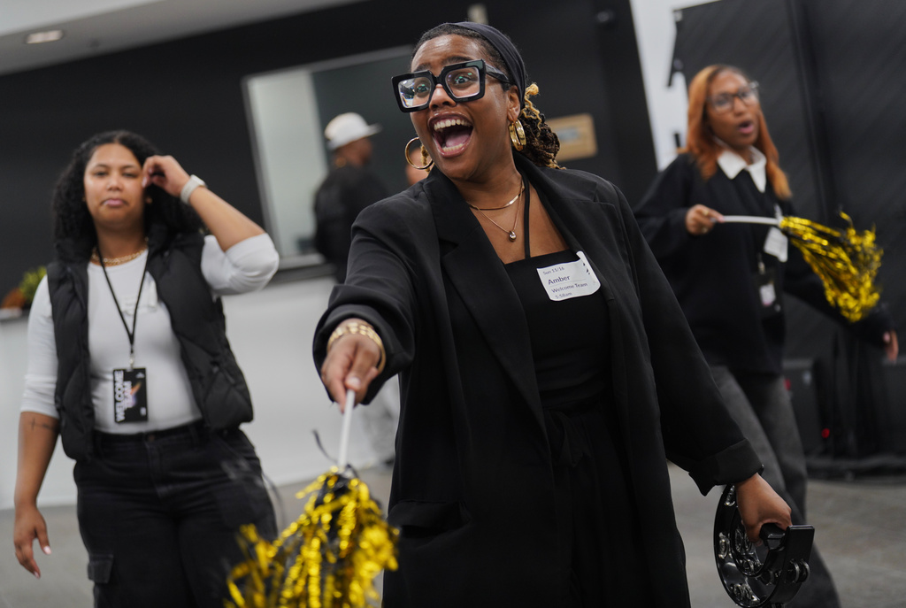 Members of the 2819 welcome team wave streamers and shake tambourines while singing popular Christian worship songs as guests enter 2819 Church on Nov. 16, 2025, in Atlanta. (AP Photo/Jessie Wardarski)