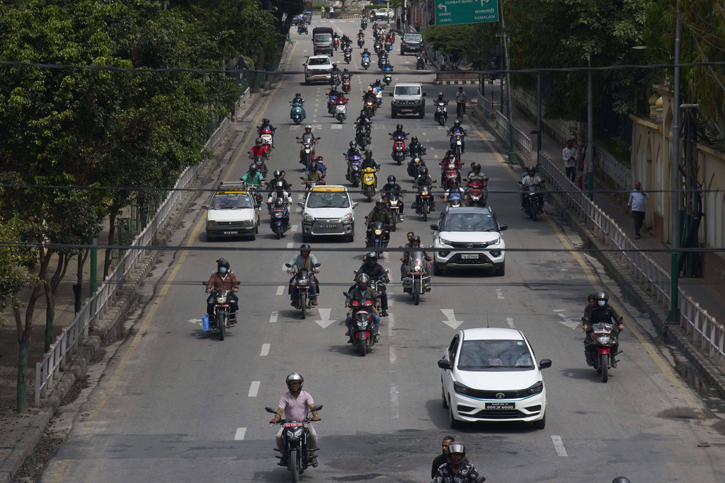 Vehicles move along the road after authorities lifted a days-long curfew imposed during anti-corruption protests sparked by a short-lived social media ban in Kathmandu, Nepal, Saturday, Sept. 13, 2025. (AP Photo/Niranjan Shrestha)
