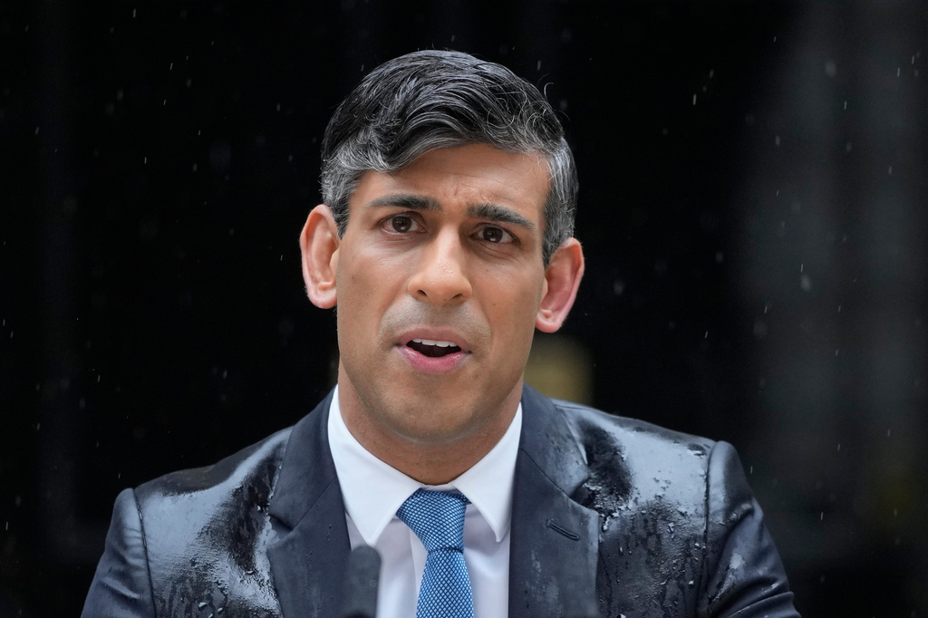 FILE - Britain's Prime Minister Rishi Sunak speaks to the media, as heavy rain falls, outside 10 Downing Street in London May 22, 2024, as he announces that he is to call a General Election for July 4. (AP Photo/Kin Cheung, File)