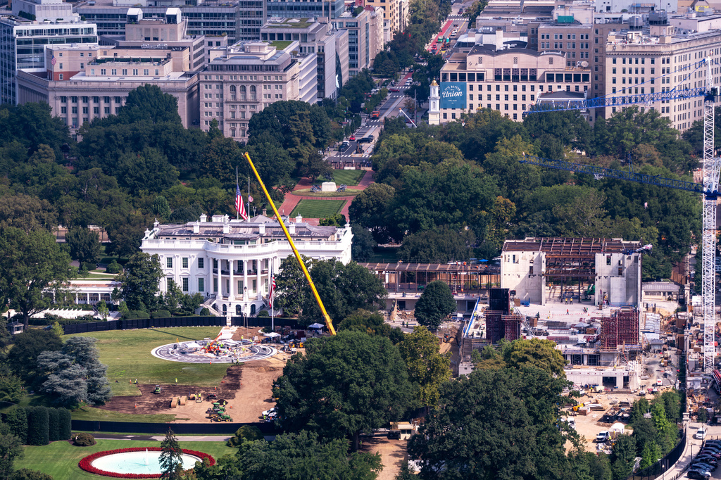 Construction continues on a helipad, left, on the South Lawn of the White House and and the new White House ballroom, right, as seen from the Washington Monument in Washington, Friday, Aug. 28, 2026. (AP Photo/J. Scott Applewhite)