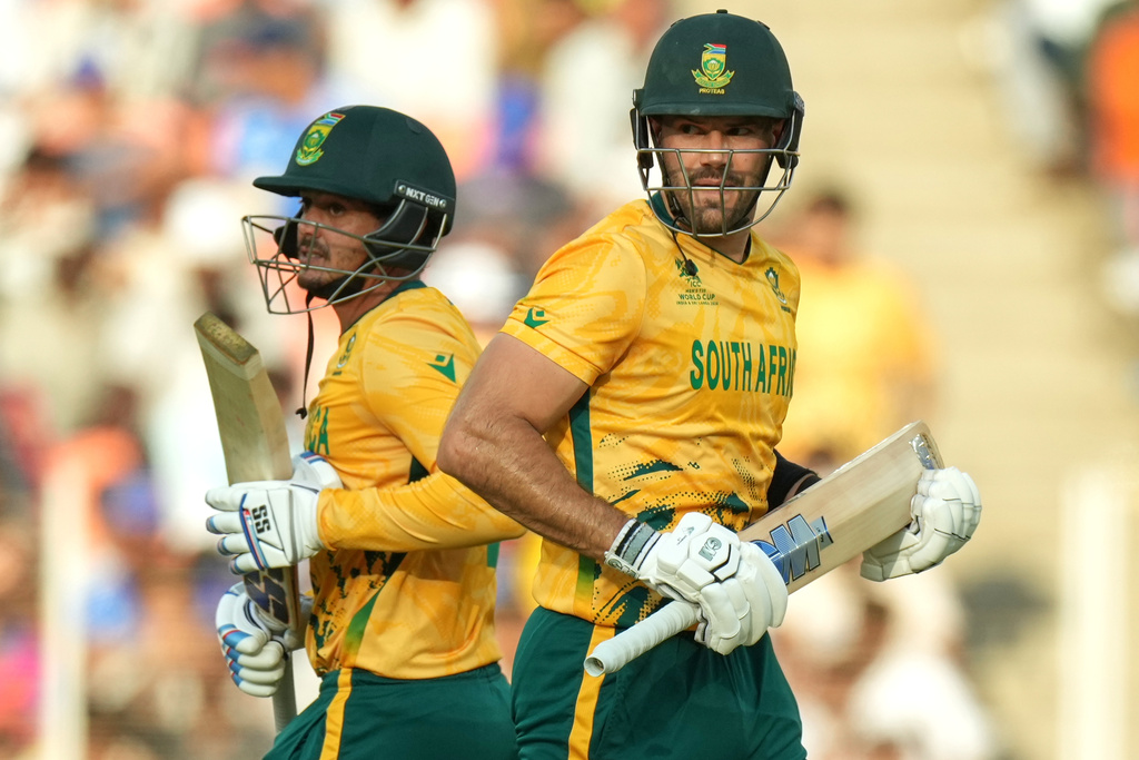South Africa's captain Aiden Markram, right, and batting partner Quinton de Kock run between the wickets during the T20 World Cup cricket match between South Africa and West Indies in Ahmedabad, India, Thursday, Feb. 26, 2026. (AP Photo/Ajit Solanki)