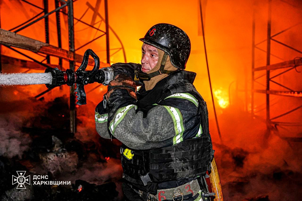 In this photo provided by the Ukrainian Emergency Services on Monday, June 8, 2026, a rescue worker puts out a fire of a storage facility after a Russian strike in Kharkiv, Ukraine. (Ukrainian Emergency Service via AP)