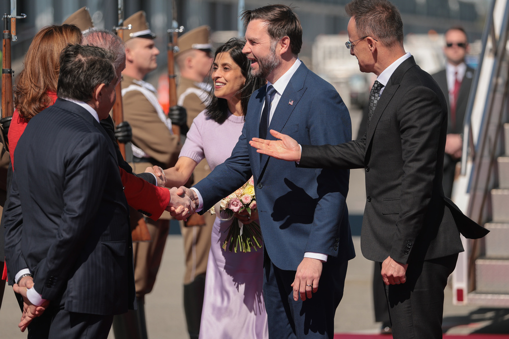 Hungarian Foreign Minister Peter Szijjarto, right, welcomes U.S. Vice President JD Vance, center right, and second lady Usha Vance, center left, as they arrive at Budapest Ferenc Liszt International Airport in Budapest, Hungary Tuesday, April 7, 2026. (Jonathan Ernst/Pool Photo via AP)