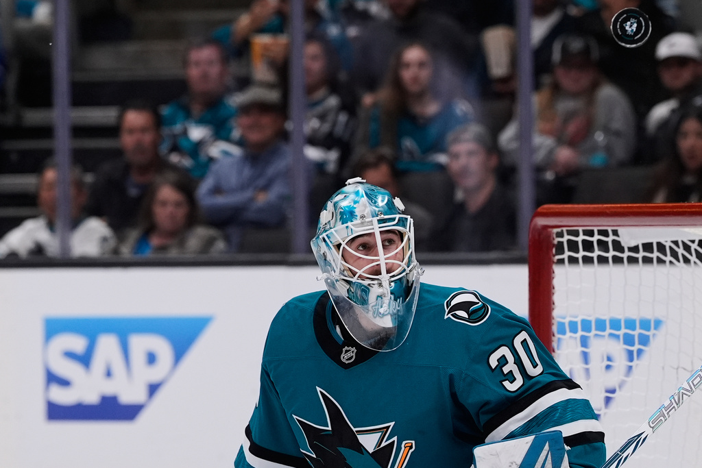San Jose Sharks goaltender Yaroslav Askarov (30) watches the puck after deflecting a shot during the second period of an NHL hockey game against the Florida Panthers, Saturday, Nov. 8, 2025, in San Jose, Calif. (AP Photo/Godofredo A. Vásquez)