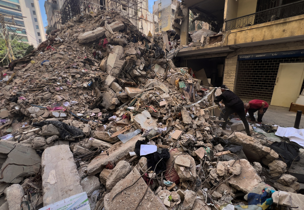 Workers search amongst the rubble of a destroyed building that was hit a week ago in an Israeli airstrike in central Beirut, Lebanon, Thursday, April 16, 2026. (AP Photo/Hussein Malla)