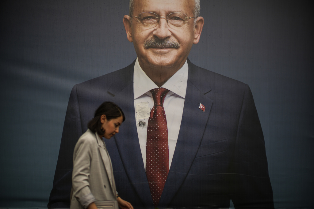 FILE - A woman walks past a billboard of then Turkish CHP party leader Kemal Kilicdaroglu in Istanbul, Turkey. (AP Photo/Emrah Gurel, File)