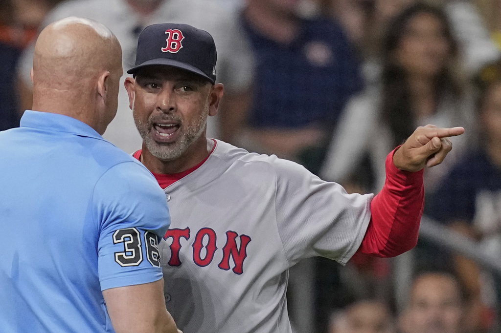 Boston Red Sox manager Alex Cora, right, argues with home plate umpire Ryan Blakney (36) after being ejected during the seventh inning of a baseball game against the Houston Astros Wednesday, Aug. 13, 2025, in Houston. (AP Photo/David J. Phillip)