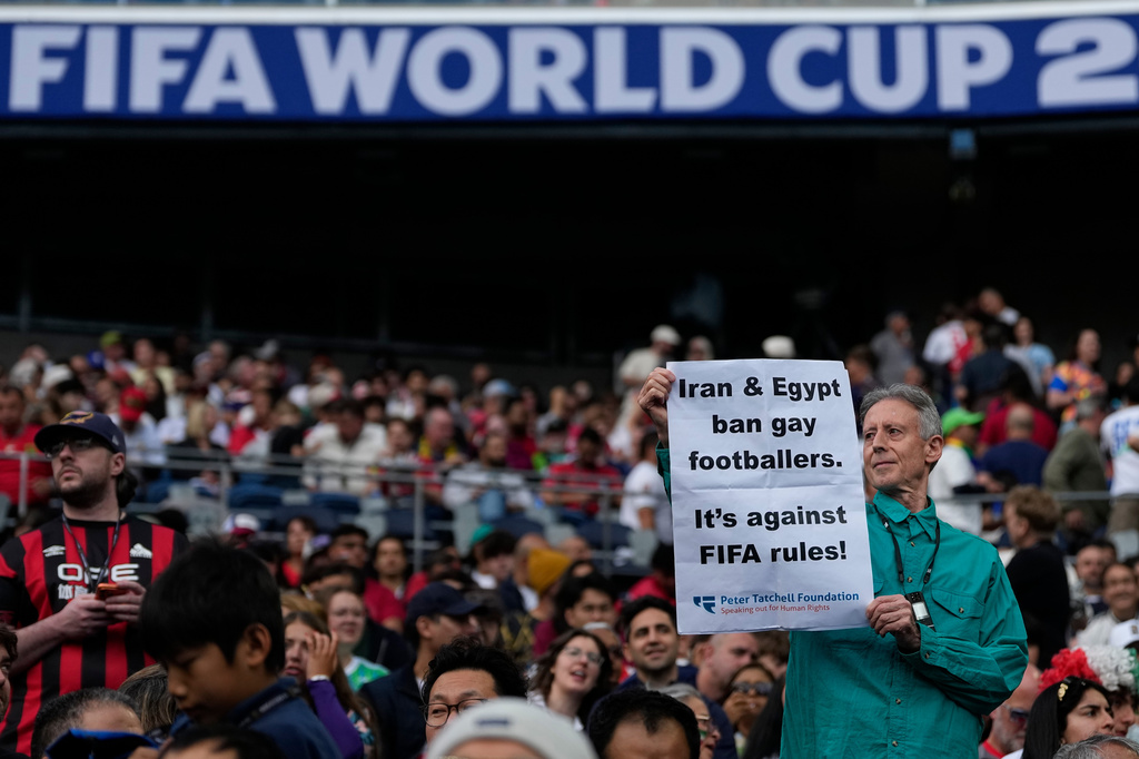 Activist Peter Tatchell holds up a placard before the start of the World Cup Group G soccer match between Egypt and Iran in Seattle, Friday, June 26, 2026. (AP Photo/Lindsey Wasson)