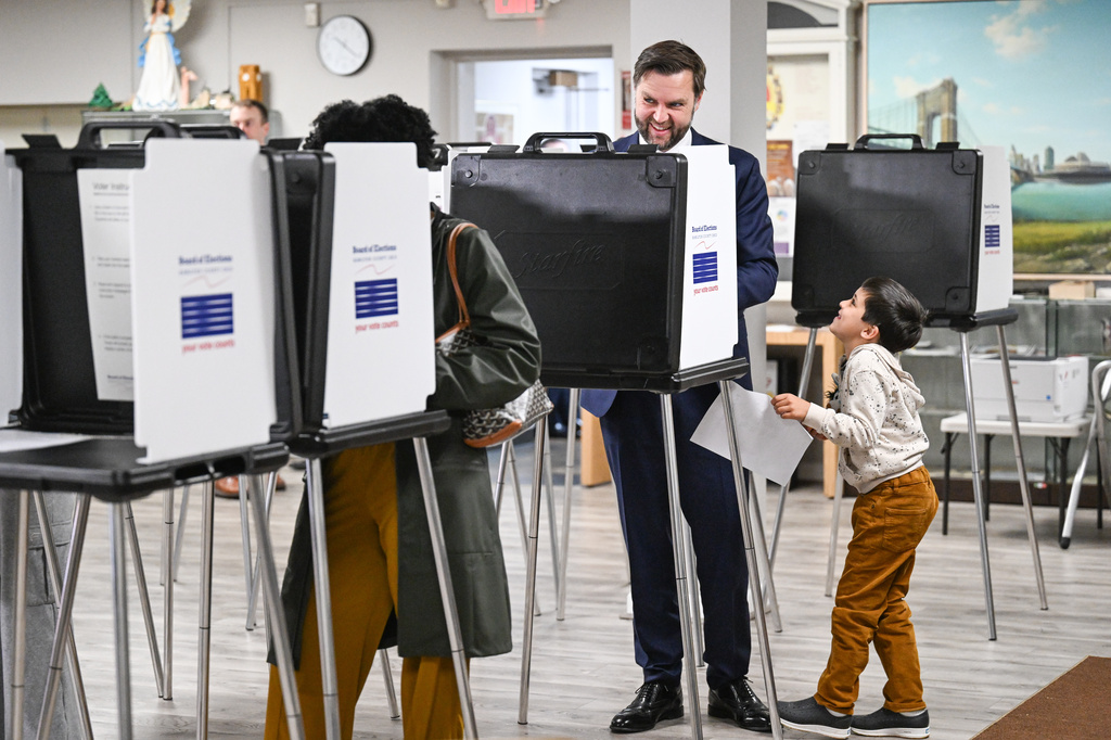 Vice President JD Vance, alongside his son Vivek, votes at a polling location at St. Anthony of Padua Maronite Catholic Church in the state's primary election, Tuesday, May 5, 2026, in Cincinnati, Ohio. Vance is stopping in Ohio to vote in the state's primary election before continuing on to Oklahoma and Iowa. (Roberto Schmidt /Pool Photo via AP)