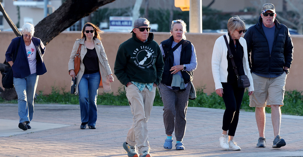 A group of people walk up to St. Philip's in the Hills Episcopal Church to attend the candlelight service for Nancy Guthrie, the 84-year-old mother of NBC "Today" show host Savannah Guthrie in Tucson, Ariz. on Wednesday, Feb. 4, 2026. (Mamta Popat/Arizona Daily Star via AP)
