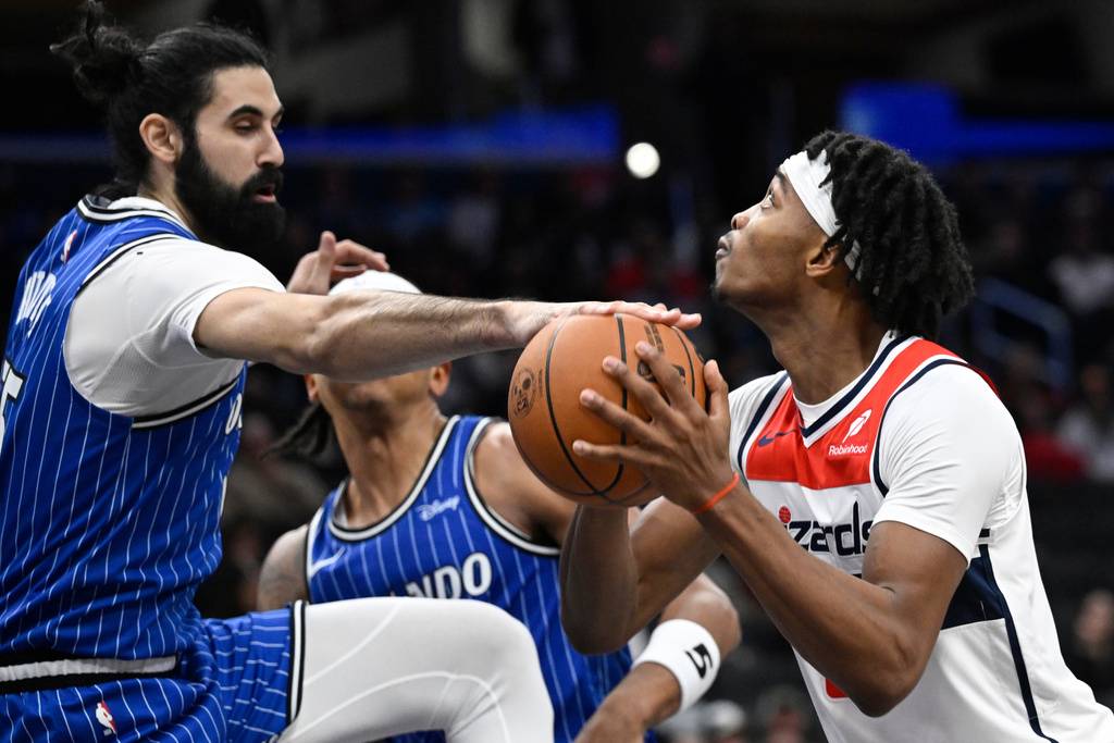 Orlando Magic center Goga Bitadze, left, blocks the shot of Washington Wizards guard Bilal Coulibaly during the first half of an NBA basketball game, Saturday, Nov. 1, 2025, in Washington. (AP Photo/John McDonnell)