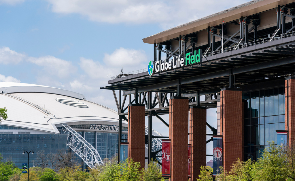 FILE - The facade of Globe Life Field stands in front of the Dallas Cowboys' AT&T Stadium before a baseball game between the Texas Rangers and the Toronto Blue Jays, April 5, 2021, in Arlington, Texas. (AP Photo/Jeffrey McWhorter, File)