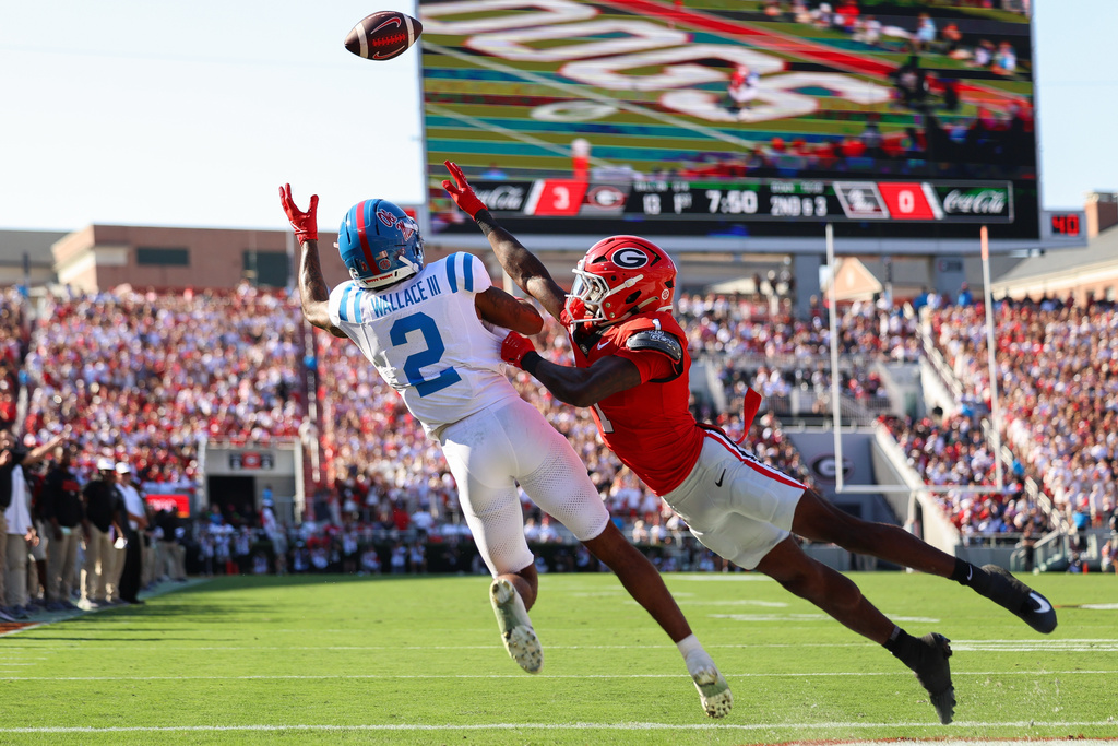 Mississippi wide receiver Harrison Wallace III (2) tries to catch a pass against Georgia defensive back Ellis Robinson IV, right, during the first half of an NCAA college football game Saturday, Oct. 18, 2025, in Athens, Ga. (AP Photo/Colin Hubbard)