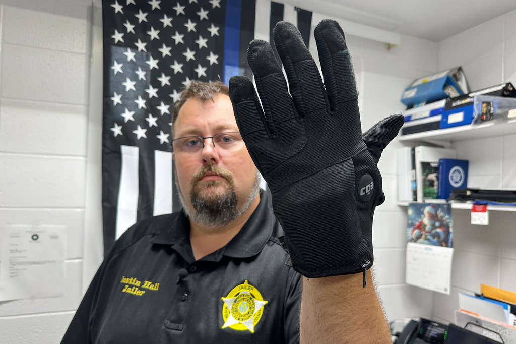 Nelson County, Ky., jailer Justin Hall shows an electric shock glove that is used at his facility, Thursday, Aug. 13, 2026, in Bardstown, Ky. (AP Photo/Dylan Lovan)