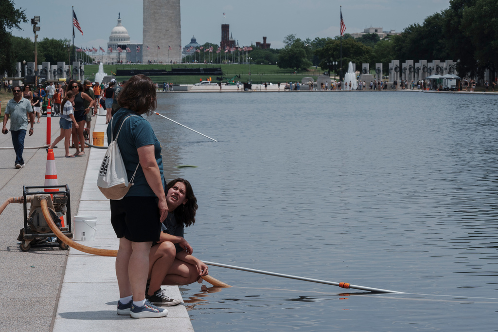 Visitors look at the Lincoln Memorial Reflecting Pool Sunday, June 21, 2026, on the National Mall in Washington. (AP Photo/Jon Elswick