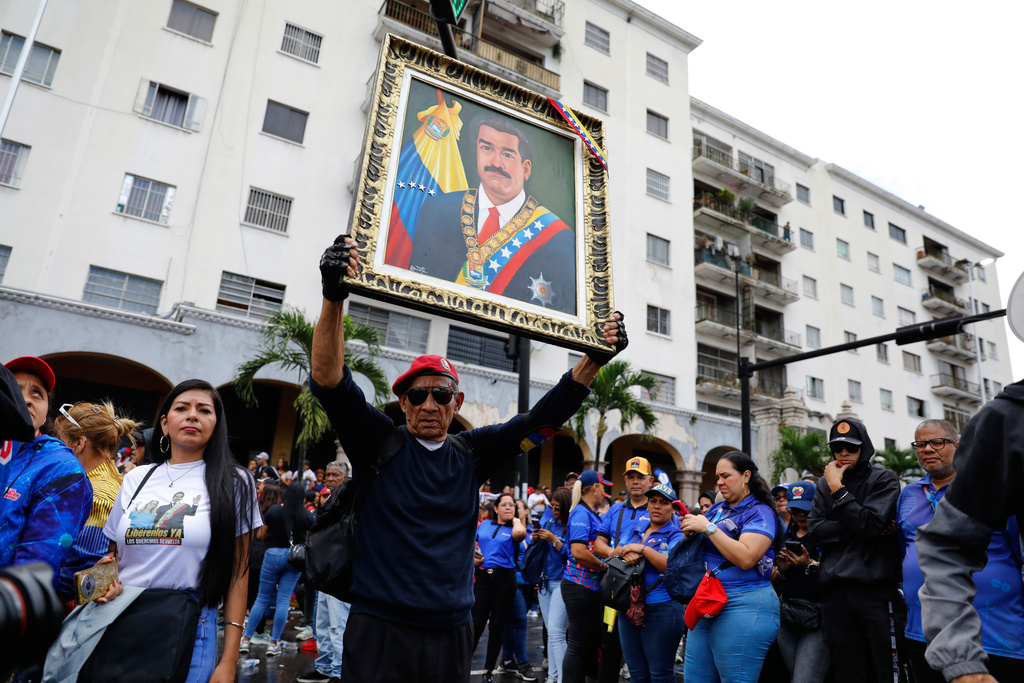 Supporters of former Venezuelan President Nicolas Maduro rally calling for his release as he faces trial in the United States after being captured by U.S. forces, in Caracas, Venezuela, Friday, Jan. 14, 2026. (AP Photo/Cristian Hernandez)