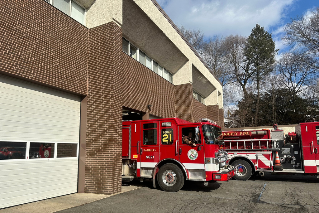 A Danbury Fire Department truck leaves the station, Sunday, Jan. 22, 2026, in Danbury, Conn. (AP Photo/Dave Collins)