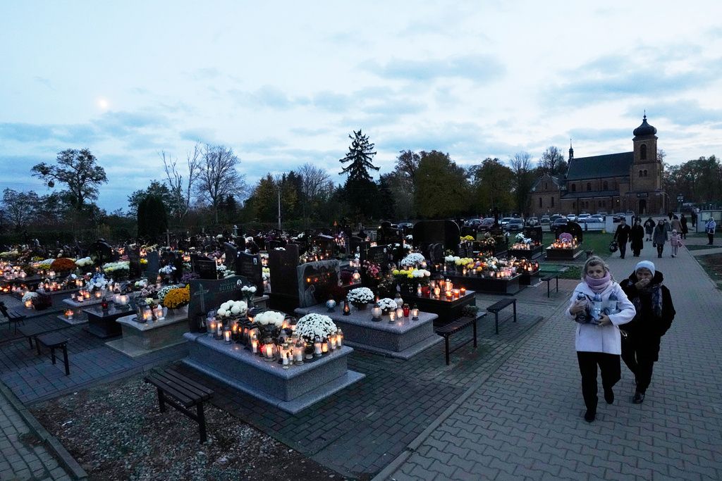 People observe All Saints' Day, a time for reflecting on those who have died, in Kroczewo near Warsaw, Poland, Saturday, Nov. 1, 2025. (AP Photo/Czarek Sokolowski)