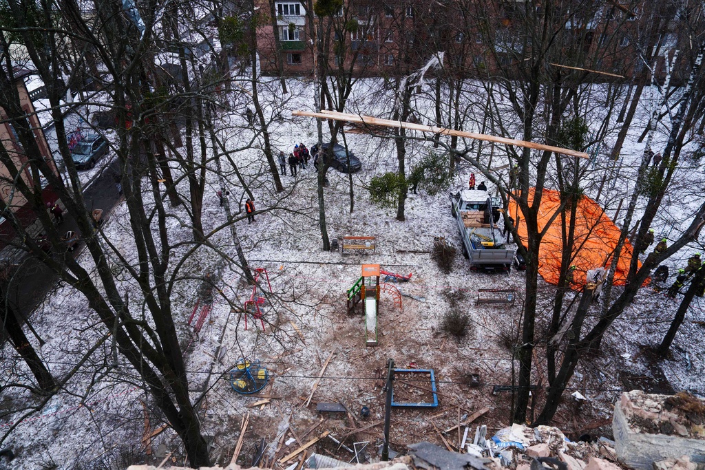 A yard is seen from the the roof of apartment building damaged after a Russian strike on Kyiv, Ukraine, on Saturday, Dec. 27, 2025. (AP Photo/Evgeniy Maloletka)